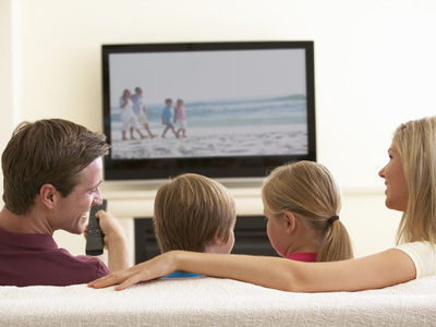 42397710 - family watching widescreen tv at home